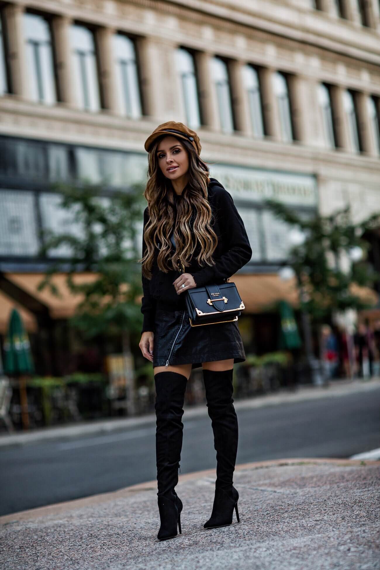 fashion blogger mia mia mine wearing over-the-knee boots and a prada cahier bag