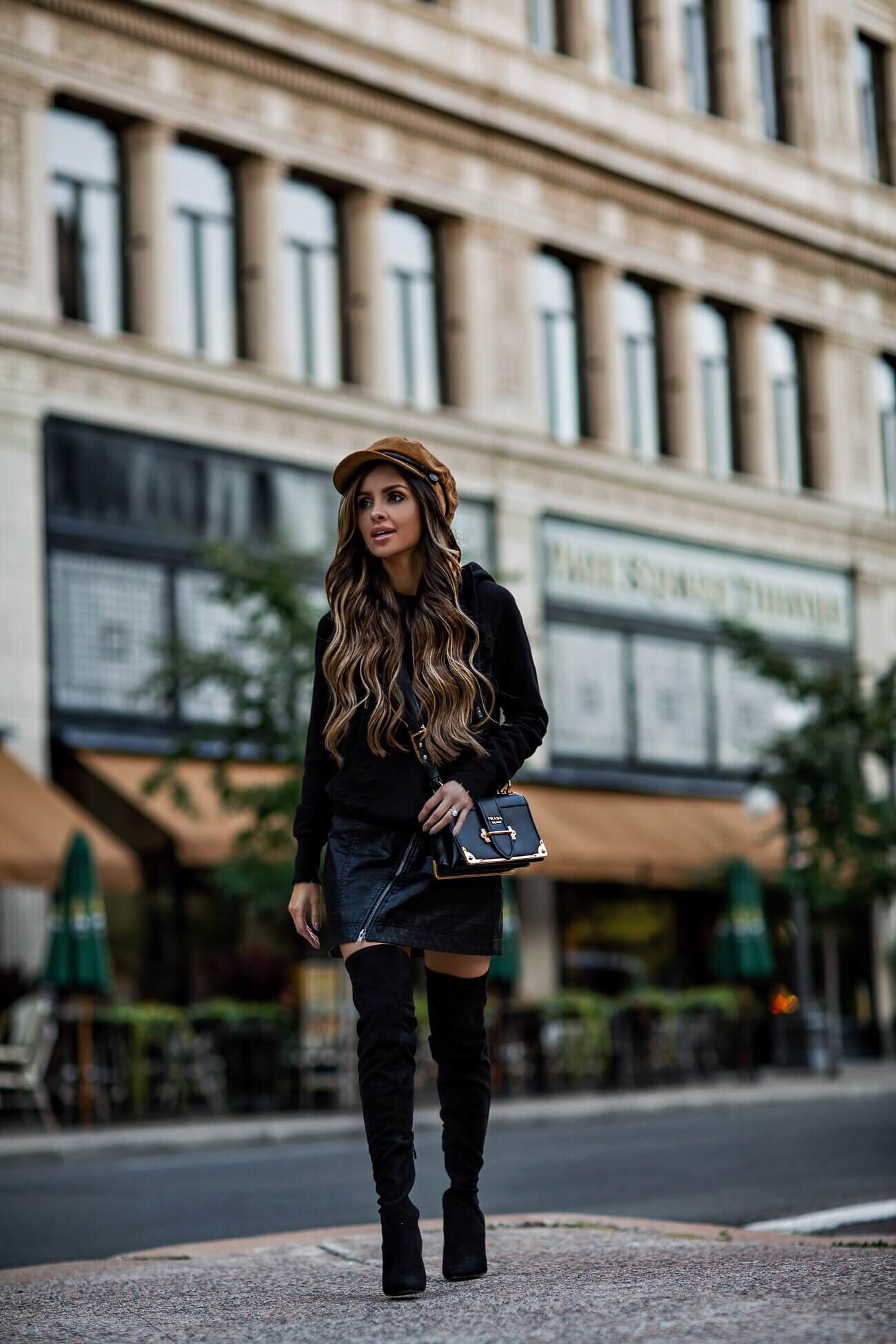 fashion blogger mia mia mine wearing a black hoodie and a brown free people baker boy hat