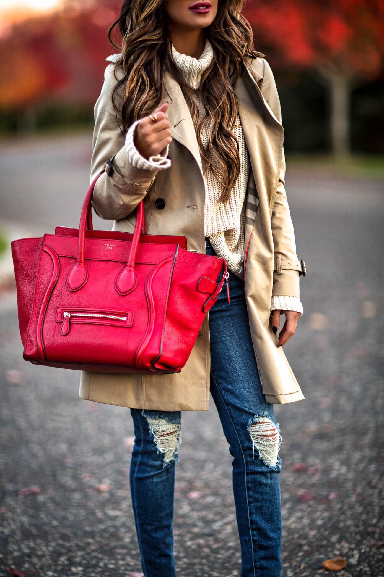 mia mia mine wearing a burberry trench coat and a red celine bag