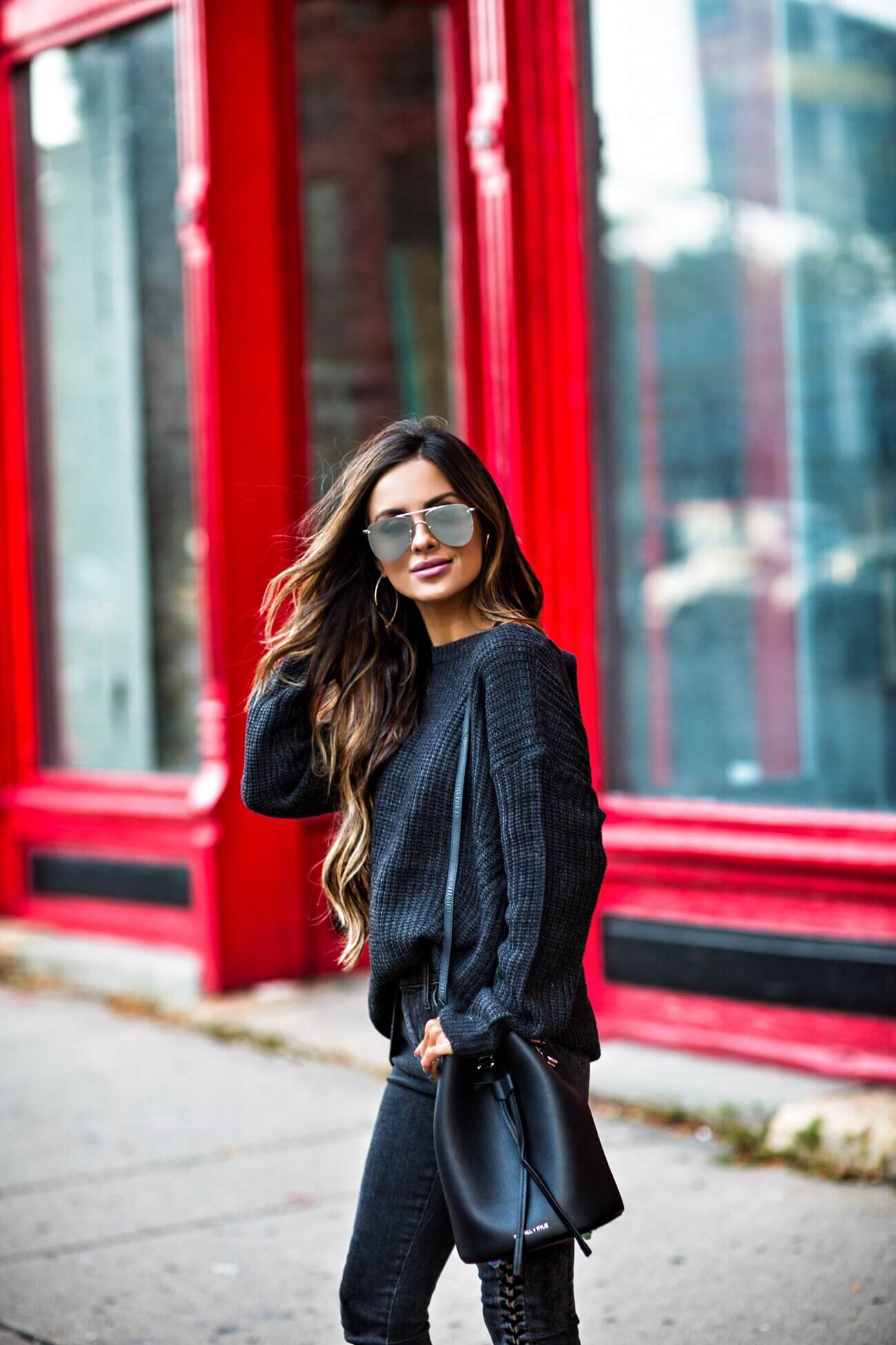 fashion blogger mia mia mine wearing a black sweater and quay sunglasses from bloomindale's