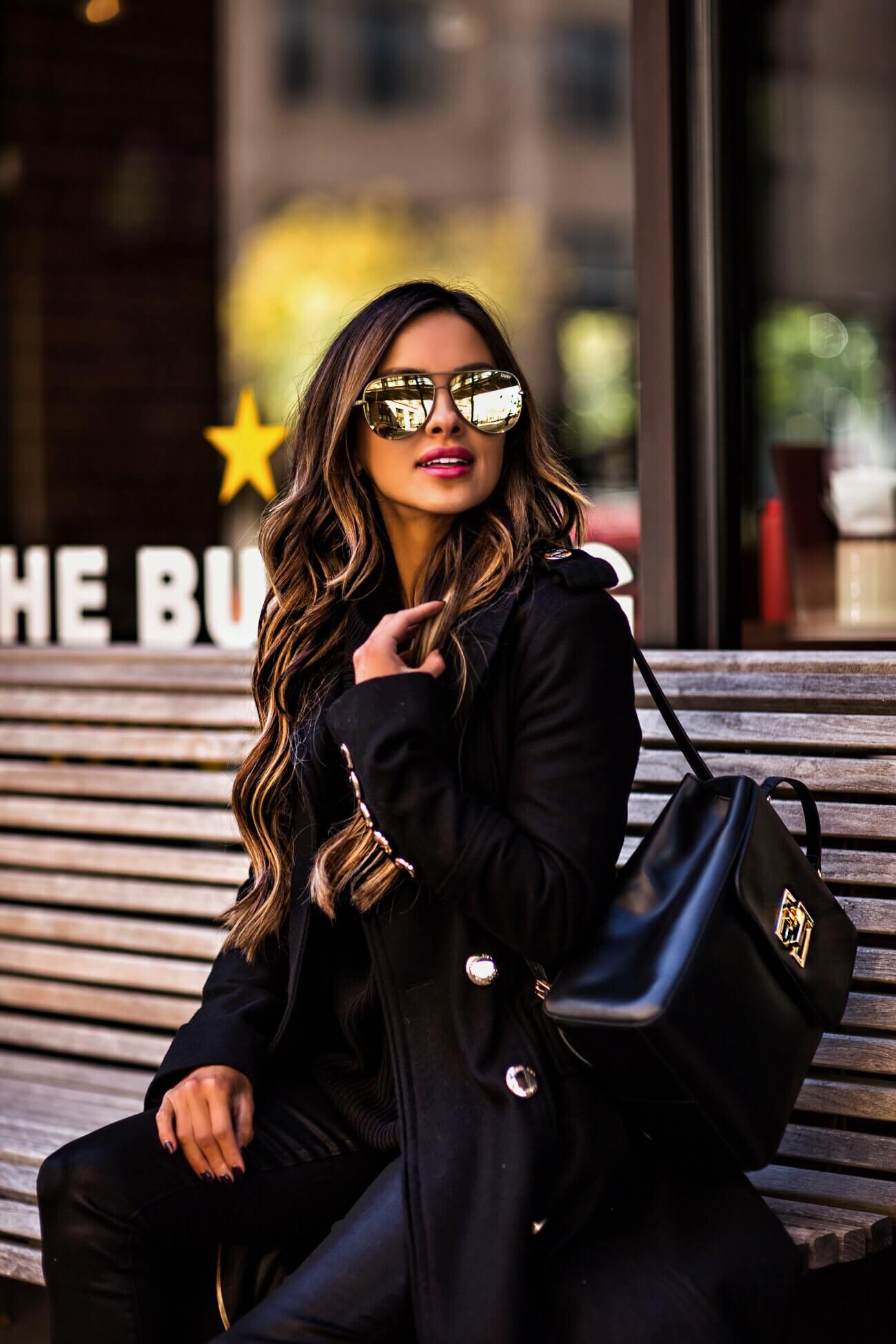 fashion blogger wearing a tommy hilfiger backpack and gold aviator sunglasses