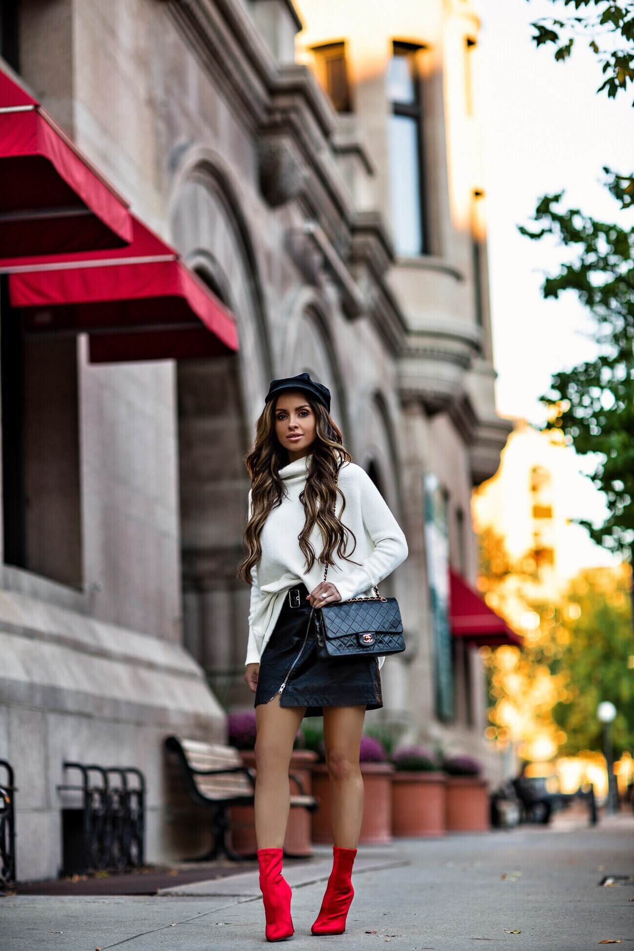 fashion blogger mia mia mine wearing a white oversized sweater and steve madden red booties