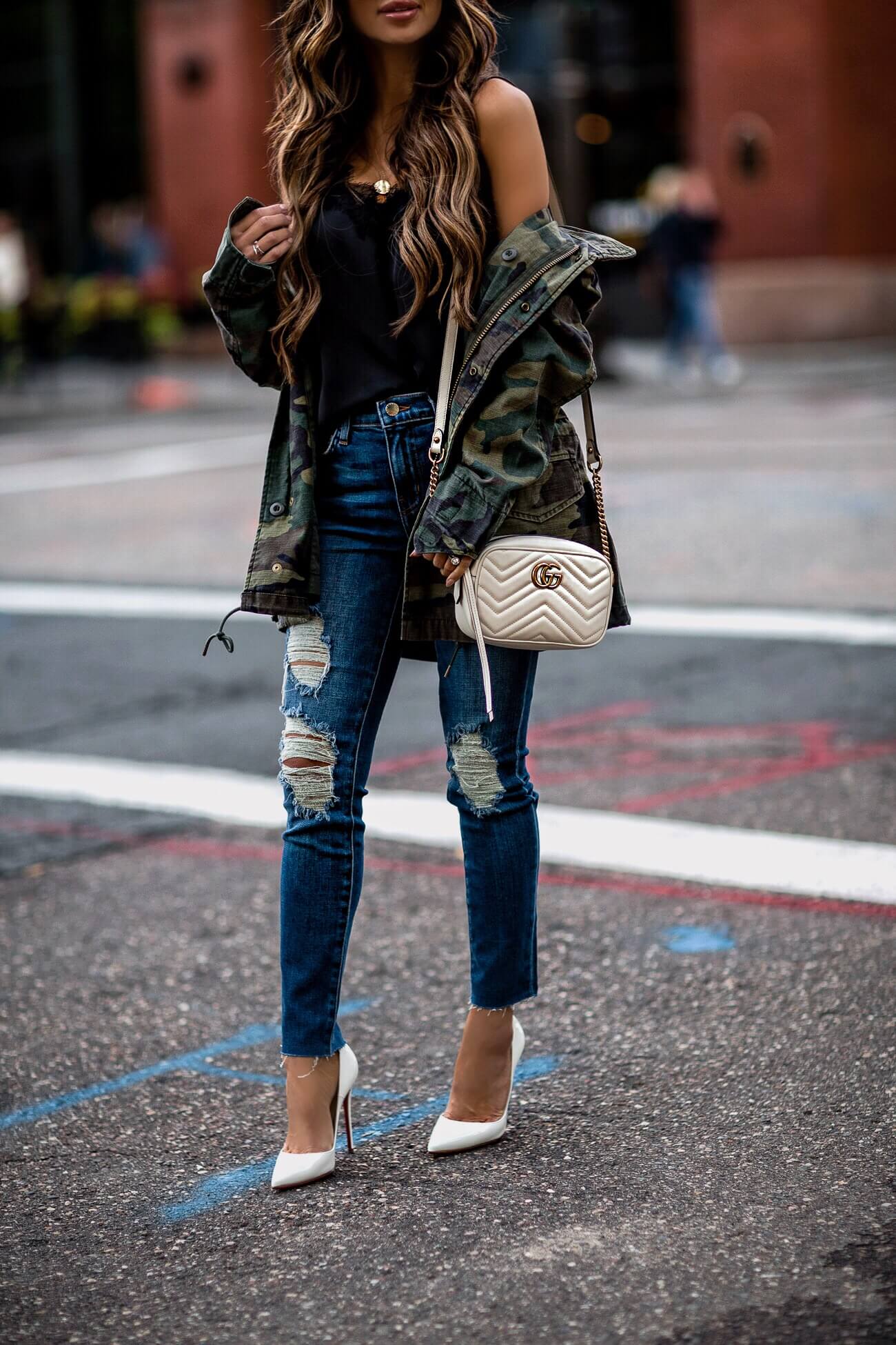 fashion blogger mia mia mine wearing distressed denim from l'agence and a camo jacket from shopbop and christian louboutin white heels
