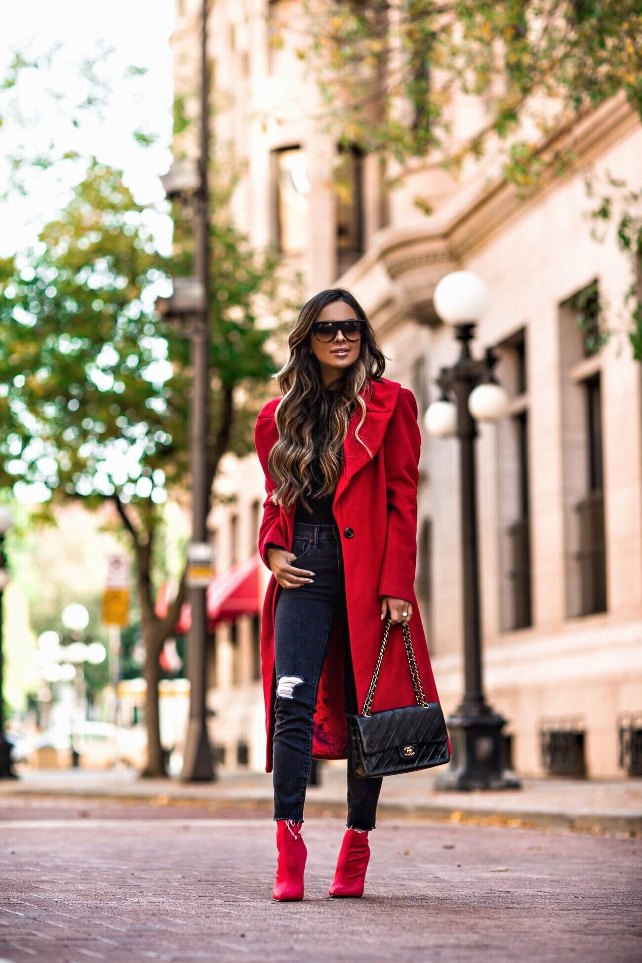 mia mia mine wearing a red coat from bloomingdale's and a chanel bag
