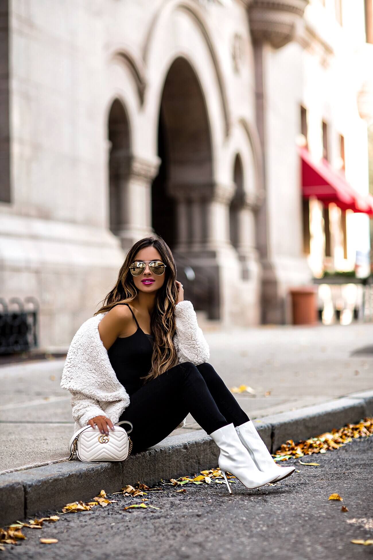 fashion blogger mia mia mine wearing a white fuzzy jacket and white booties by steve madden