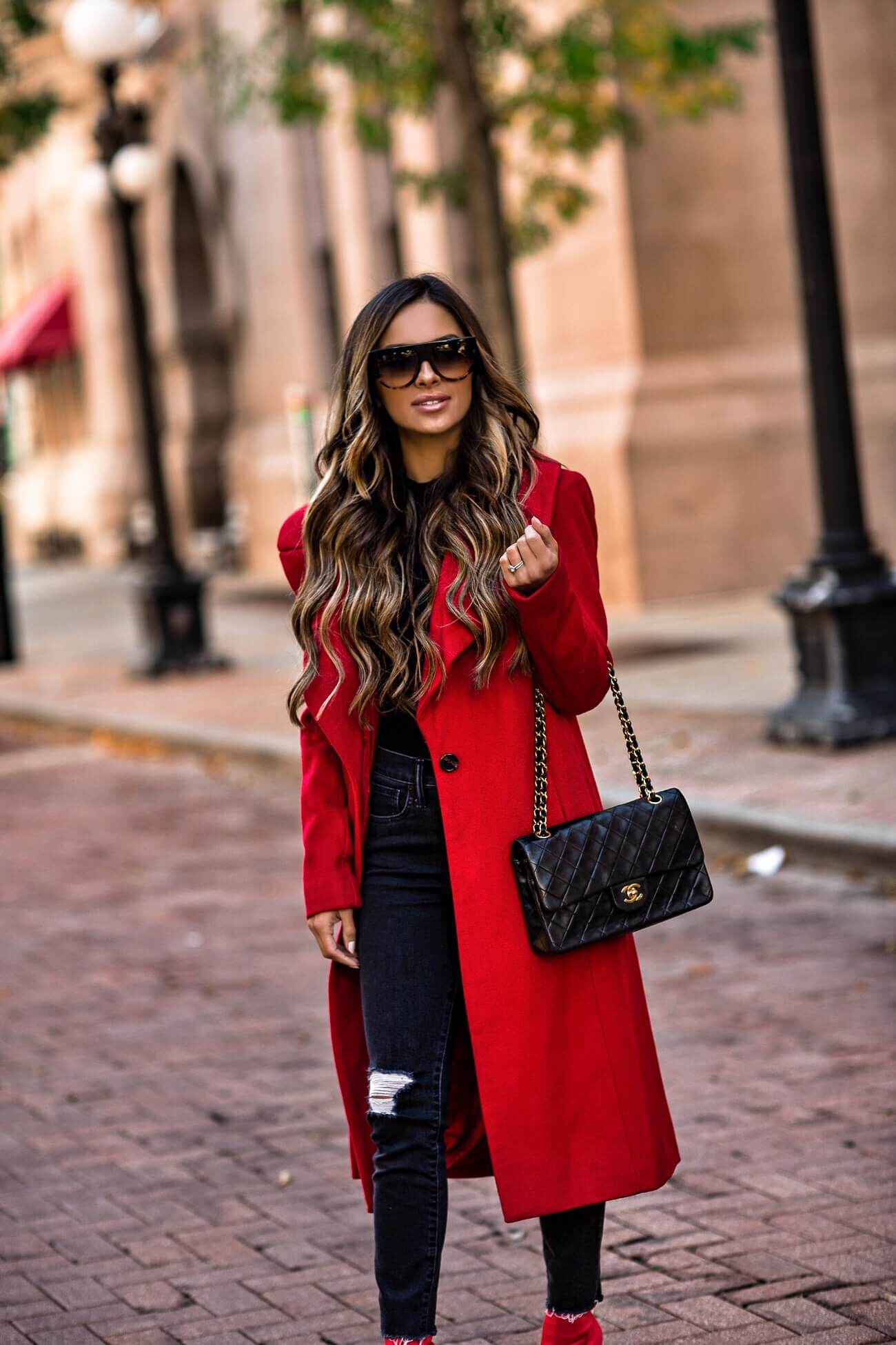 fashion blogger mia mia mine wearing a red coat from bloomingdale's