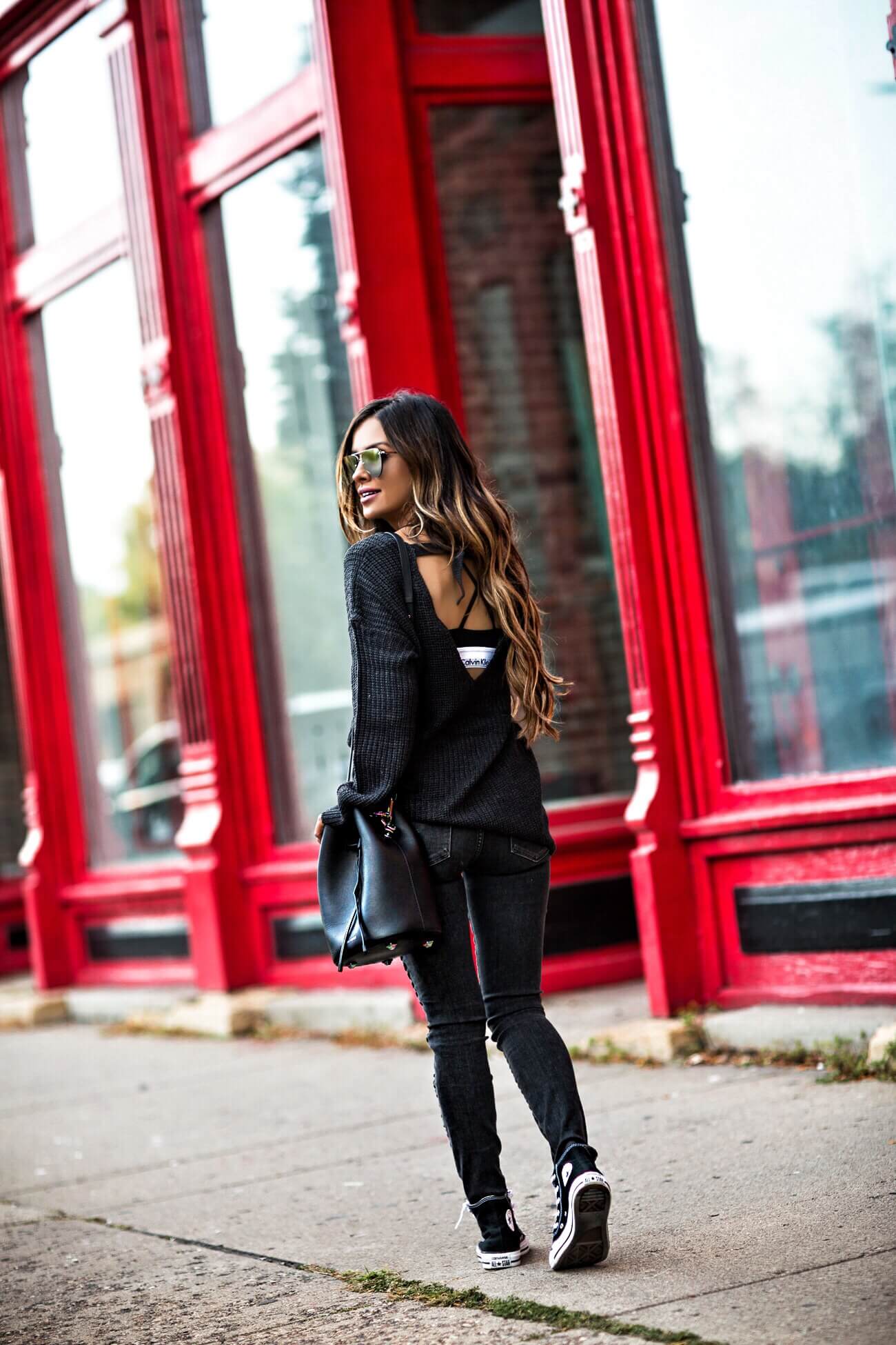 fashion blogger mia mia mine wearing a backless sweater and a calvin klein bra