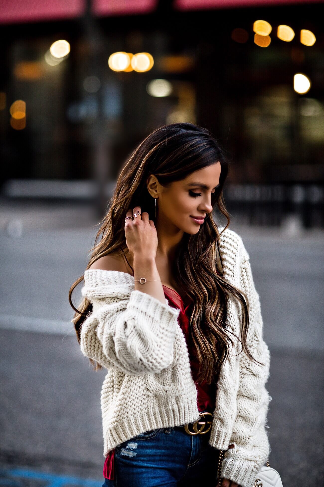 fashion blogger mia mia mine wearing a white cable knit sweater and aurate jewelry
