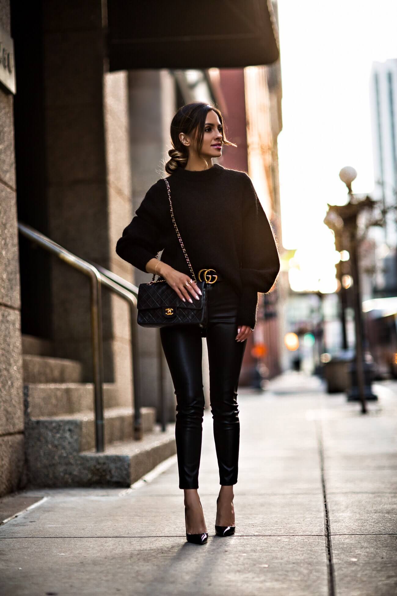 fashion blogger mia mia mine wearing a black sweater from H&M and a chanel bag