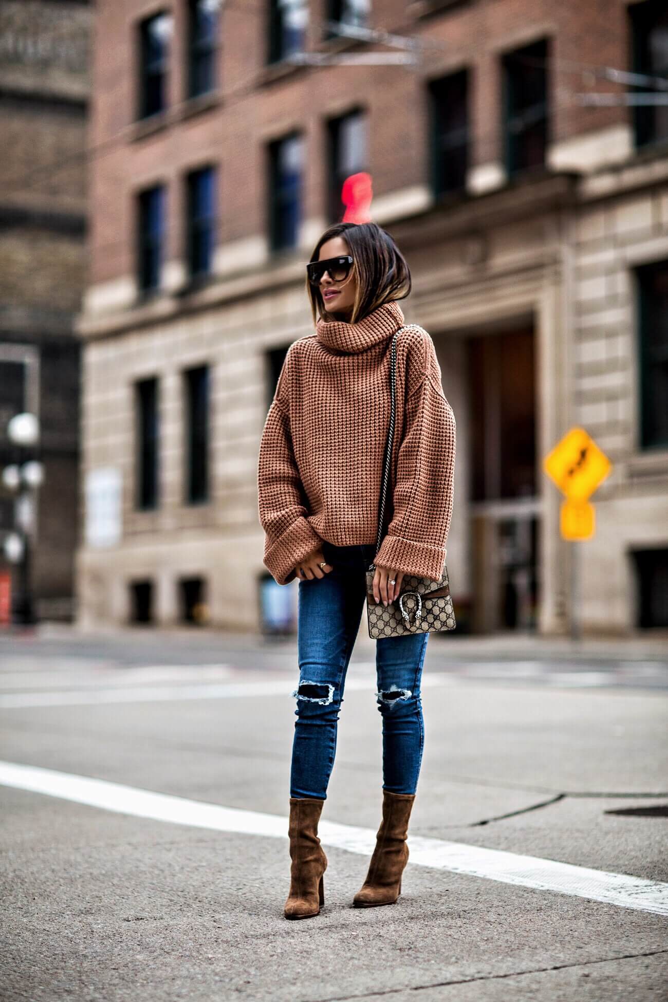 fashion blogger mia mia mine wearing a chunky knit sweater and ag denim