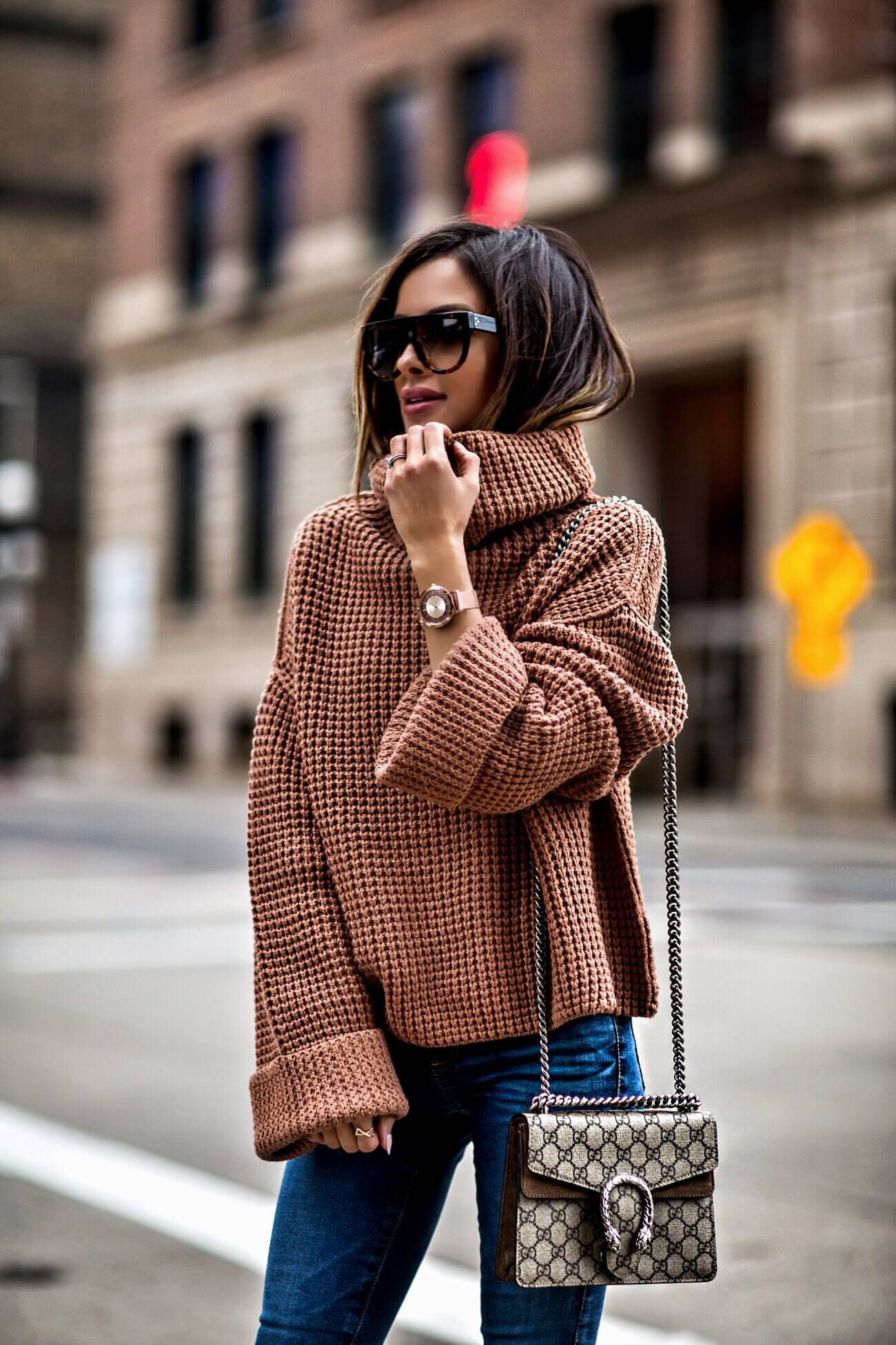 fashion blogger mia mia mine wearing a free people turtleneck and a gucci dionysus bag