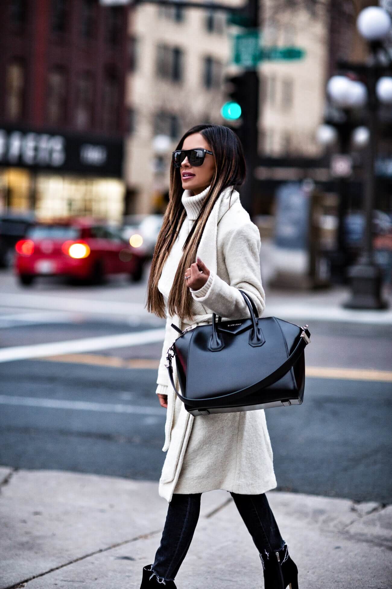 mia mia mine wearing a white wrap coat and a black givenchy antigona bag
