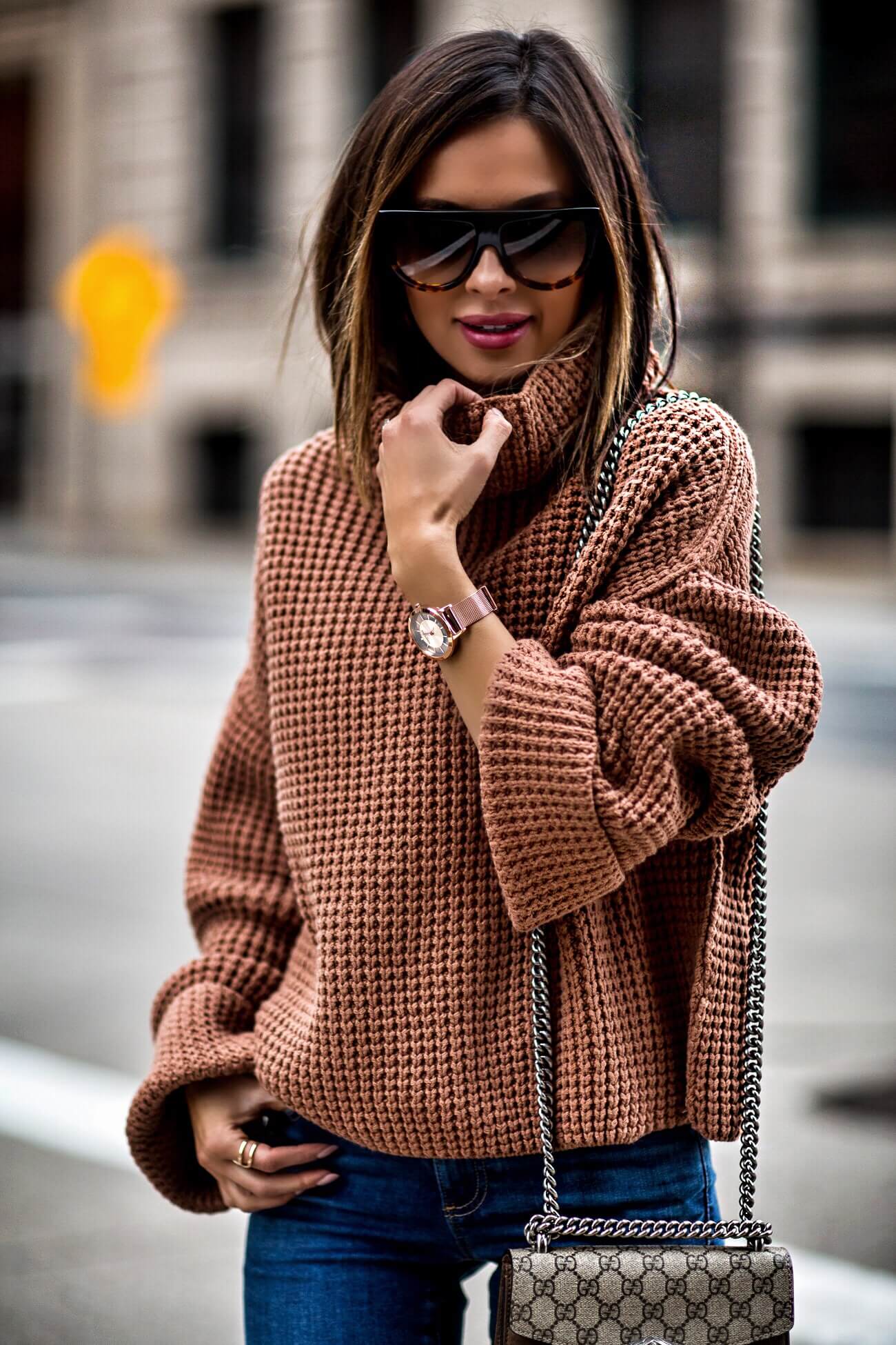 fashion blogger mia mia mine wearing an orange sweater by free people and a kenneth cole watch