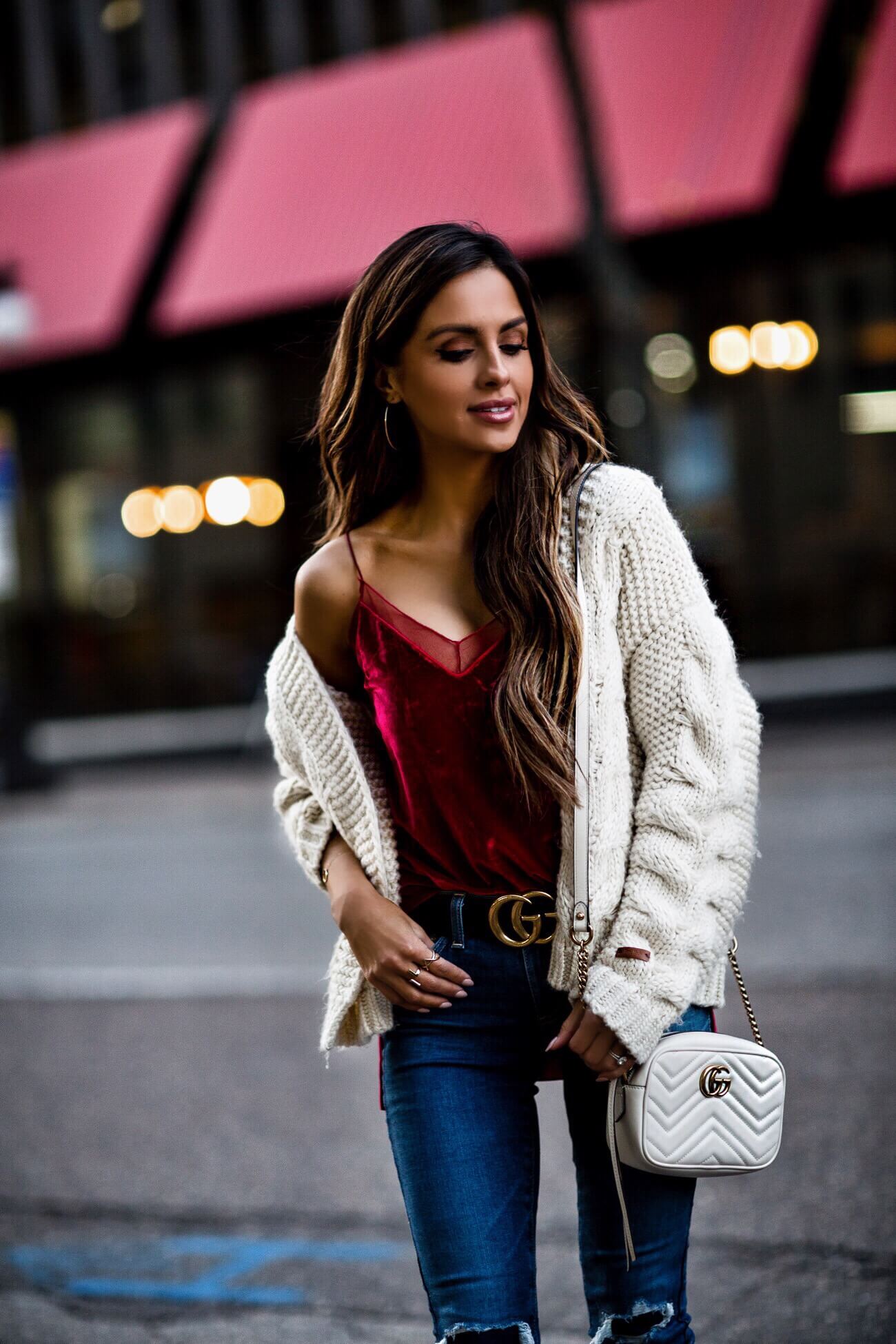 fashion blogger mia mia mine wearing a red velvet cami and a gucci belt