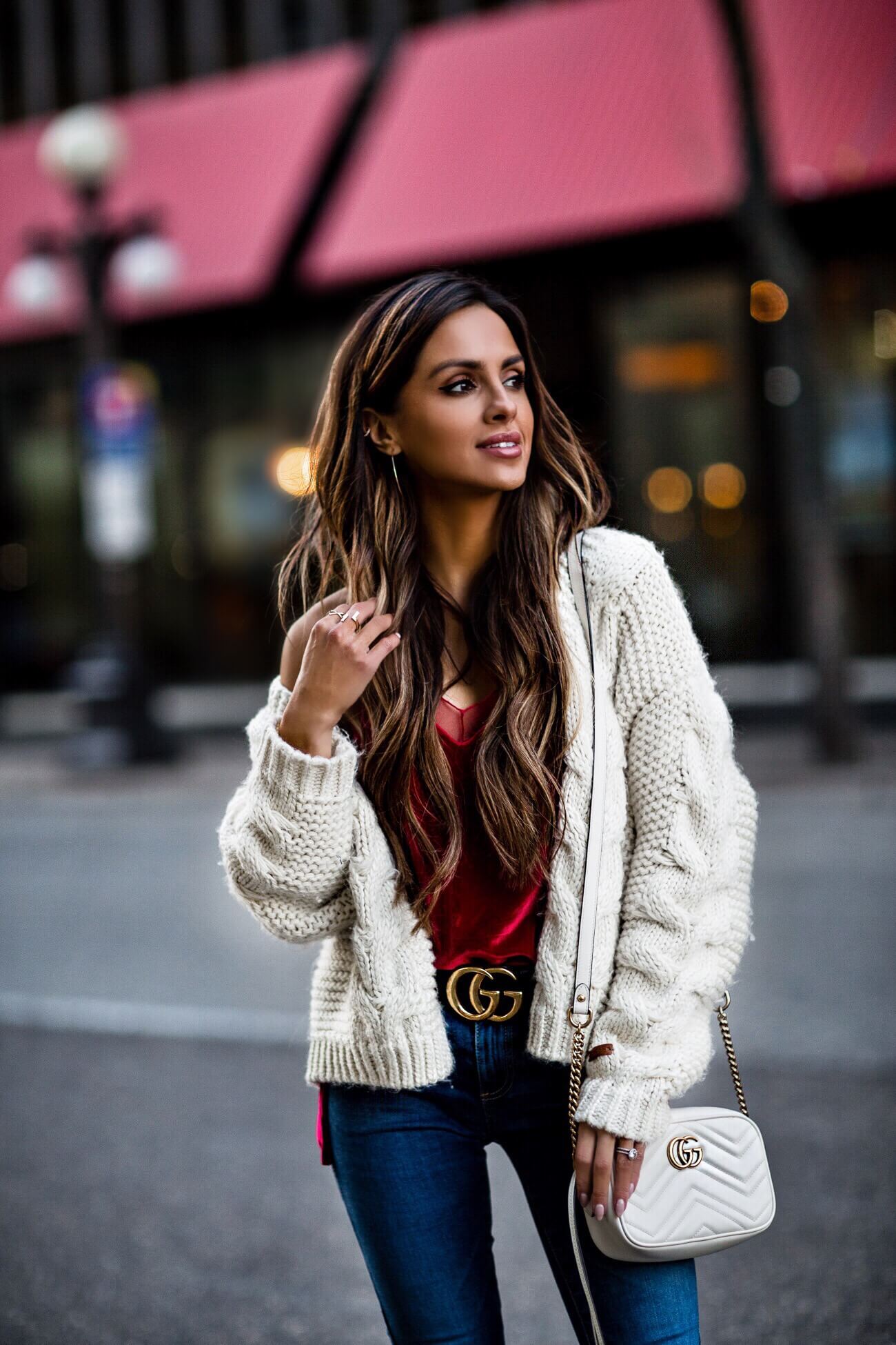 fashion blogger mia mia mine wearing a red velvet cami and cable knit cardigan