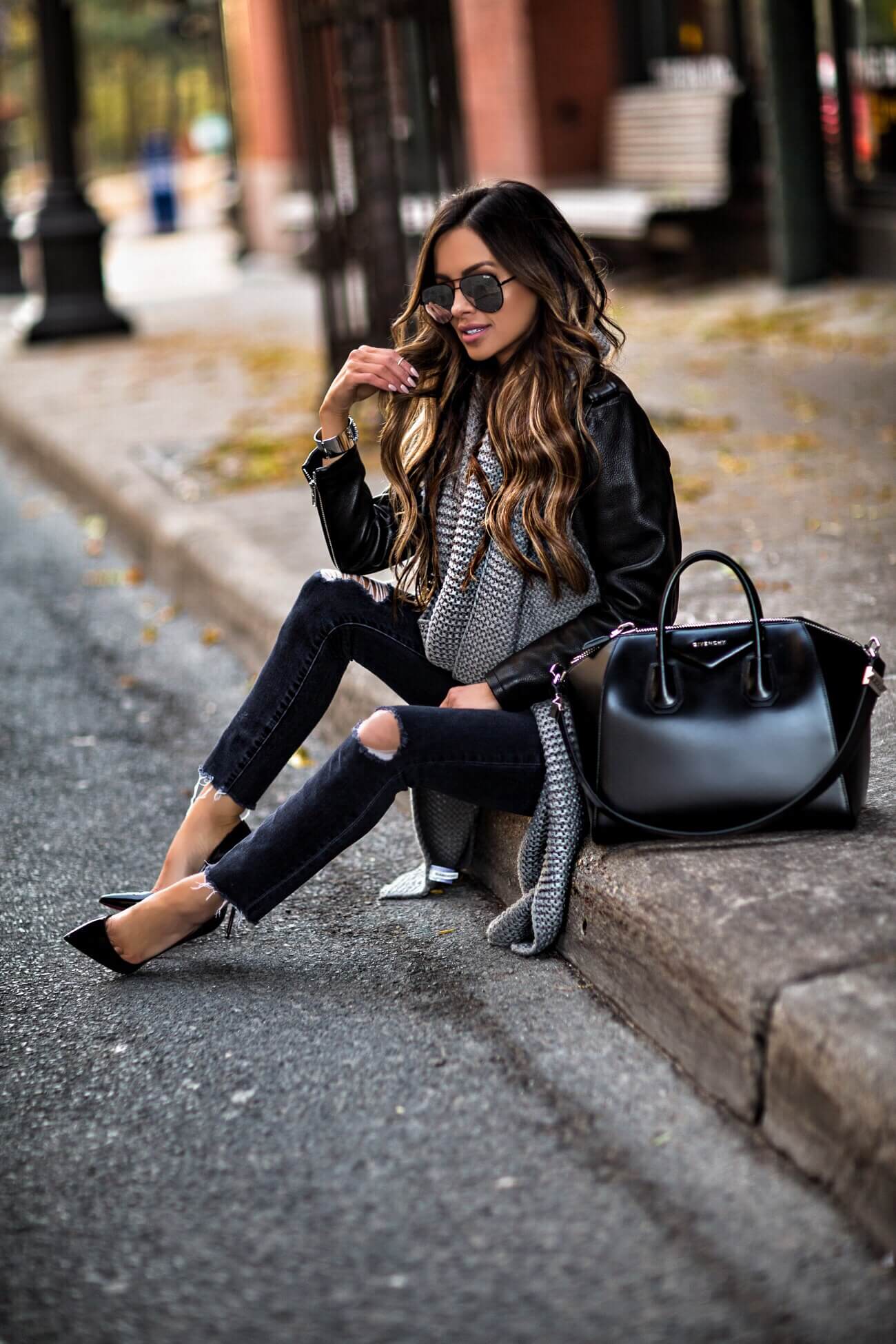 fashion blogger mia mia mine wearing a gray knit scarf and a givenchy antigona bag