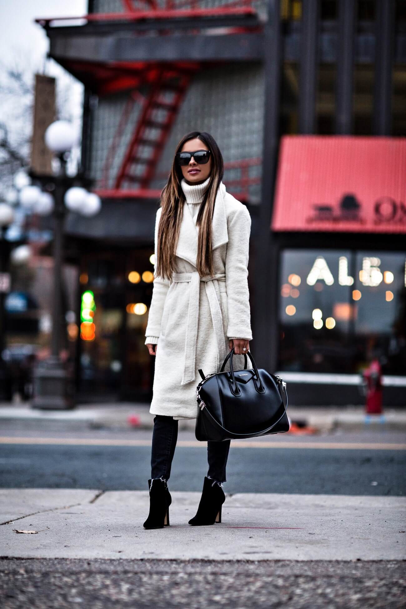 fashion blogger mia mia mine wearing a white coat and givenchy antigona bag