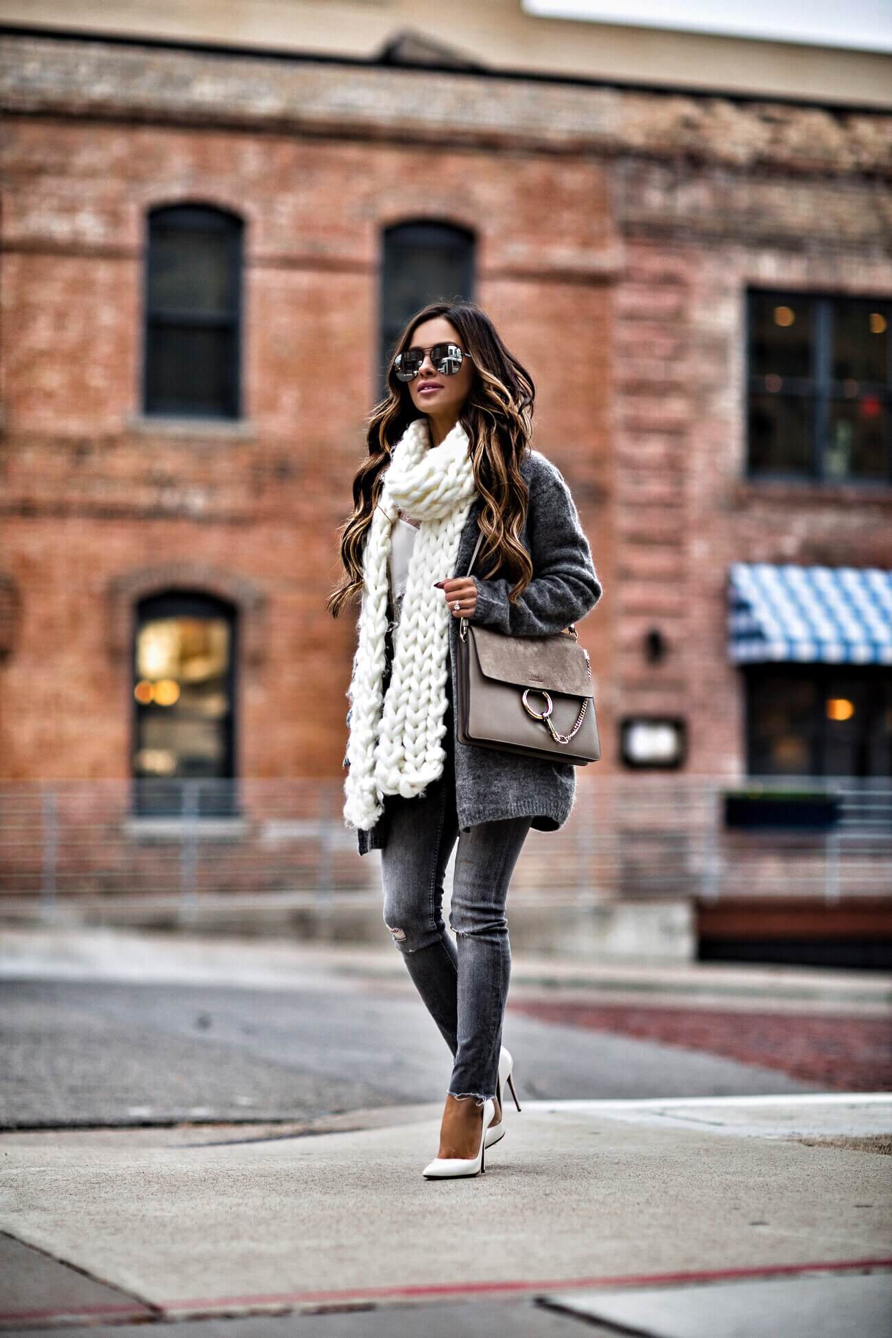 mia mia mine wearing a white chunky scarf and gray denim