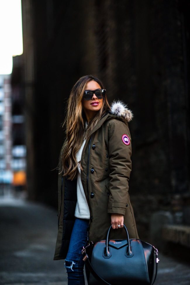 fashion blogger mia mia mine wearing a canada goose jacket and a givenchy bag