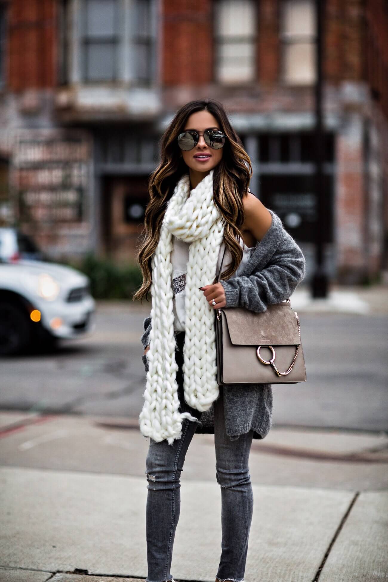 fashion blogger mia mia mine wearing a chunky knit scarf from free people