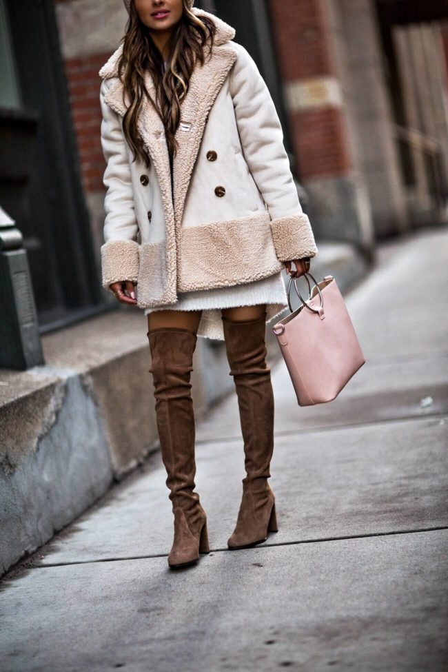 Fashion blogger wearing over the knee Stuart Weitzman boots from Bloomingdales