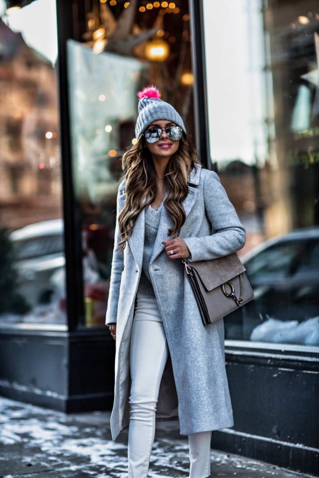 fashion blogger mia mia mine wearing a gray coat from club monaco and an H&M beanie