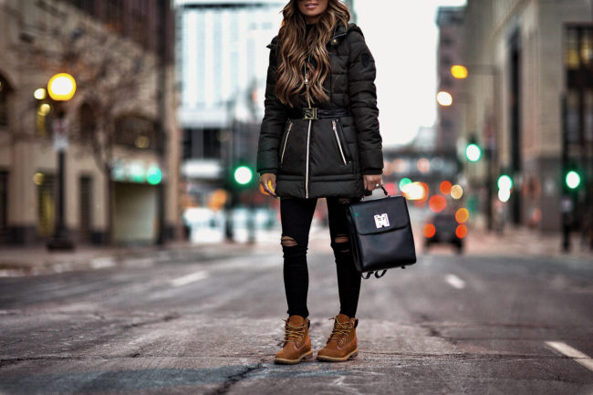 fashion blogger mia mia mine wearing a winter coat from macy's and timberland boots