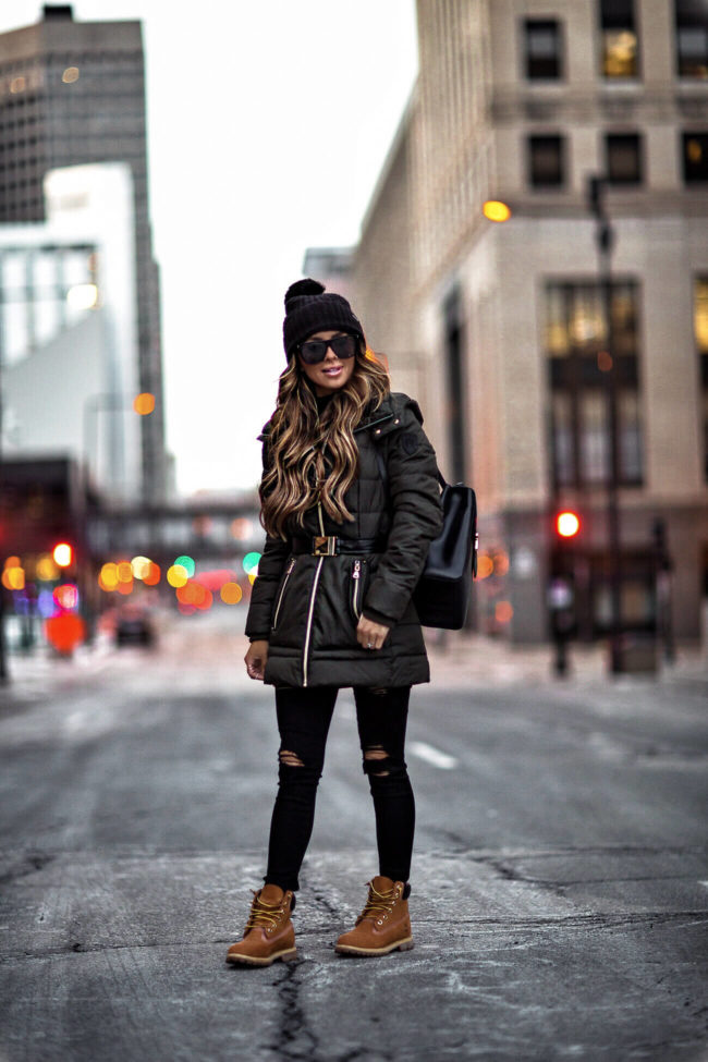 fashion blogger mia mia mine wearing a green coat from macy's and timberland boots