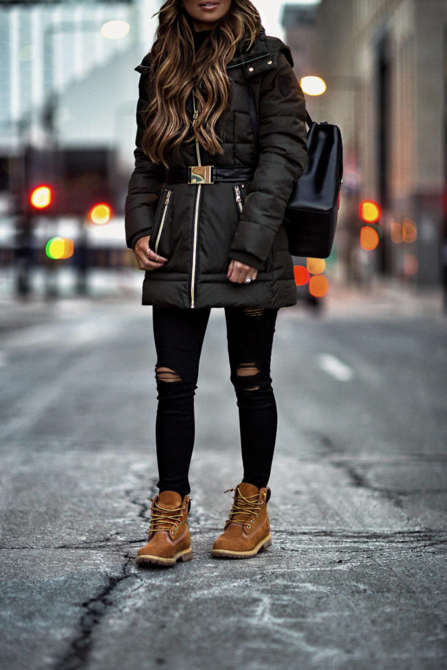 fashion blogger mia mia mine wearing timberland boots and a green vince camuto jacket