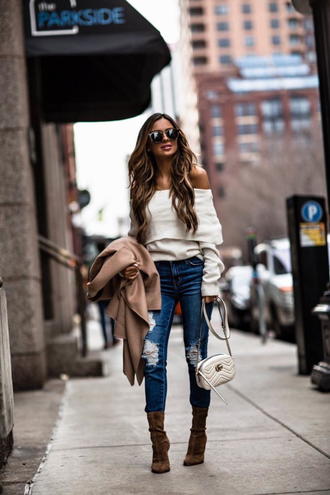 fashion blogger mia mia mine wearing a white off the shoulder sweater and a camel coat from nordstrom