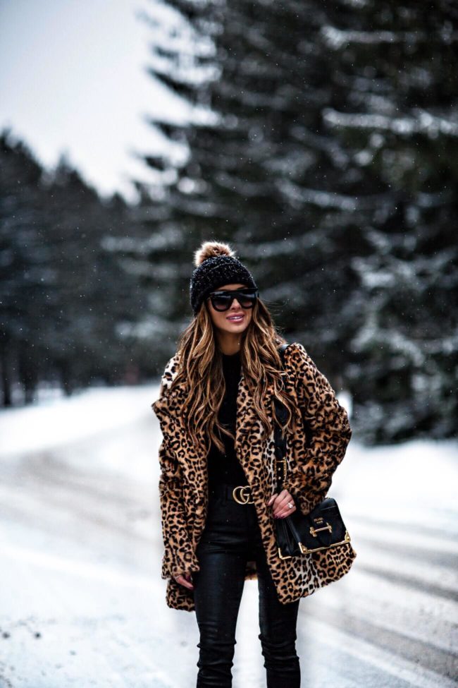 mia mia mine wearing a pom pom beanie and leopard coat from nordstrom