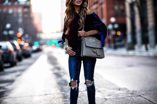 fashion blogger mia mia mine wearing levi's denim and a blue velvet top by free people
