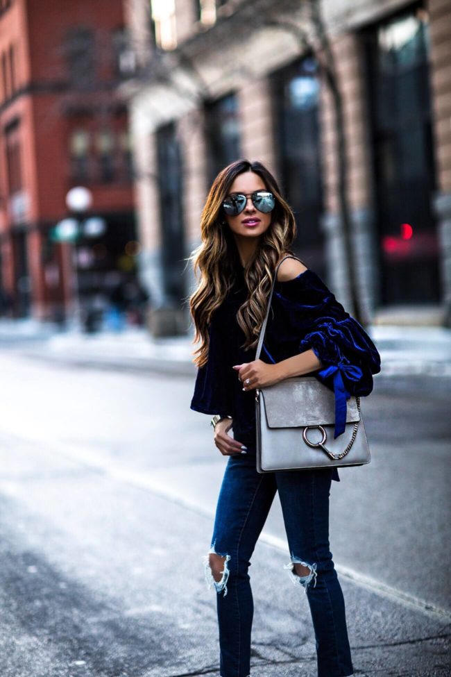 fashion blogger mia mia mine wearing a blue velvet top and chloe faye bag