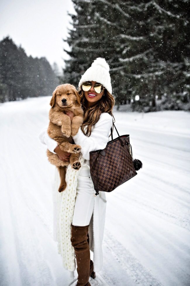 fashion blogger mia mia mine wearing a white cardigan sweater from nordstrom with golden retriever puppy