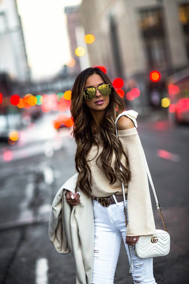fashion blogger mia mia mine wearing a lovers + friends sweater and distressed white denim