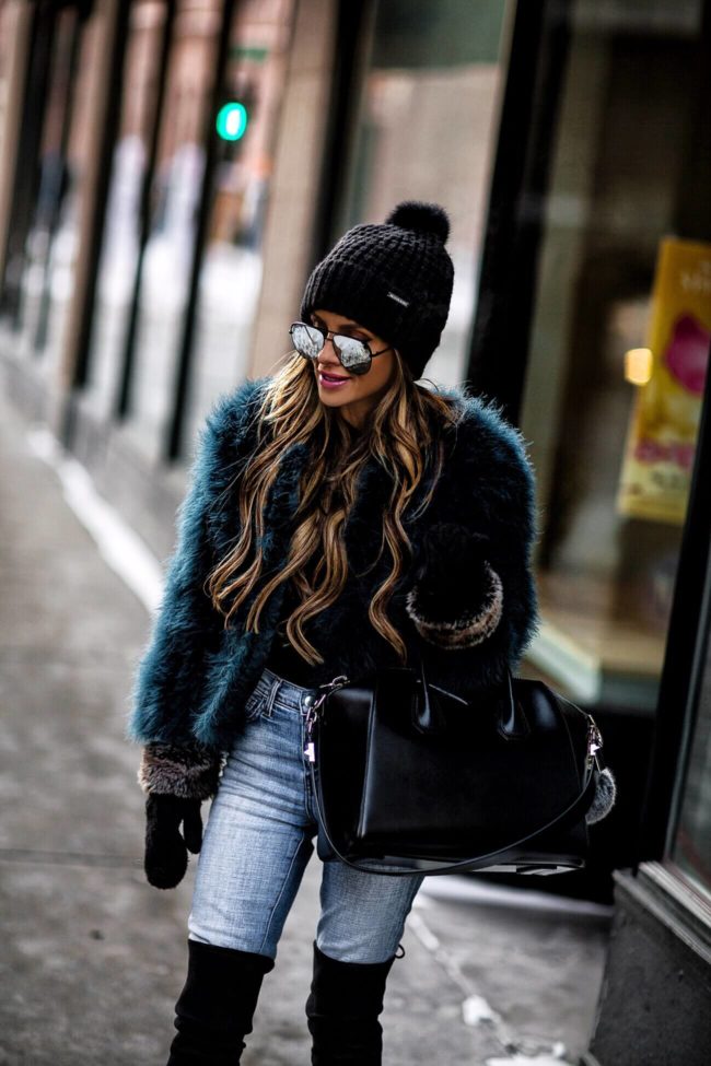 fashion blogger mia mia mine wearing a faux fur jacket and givenchy antigona tote
