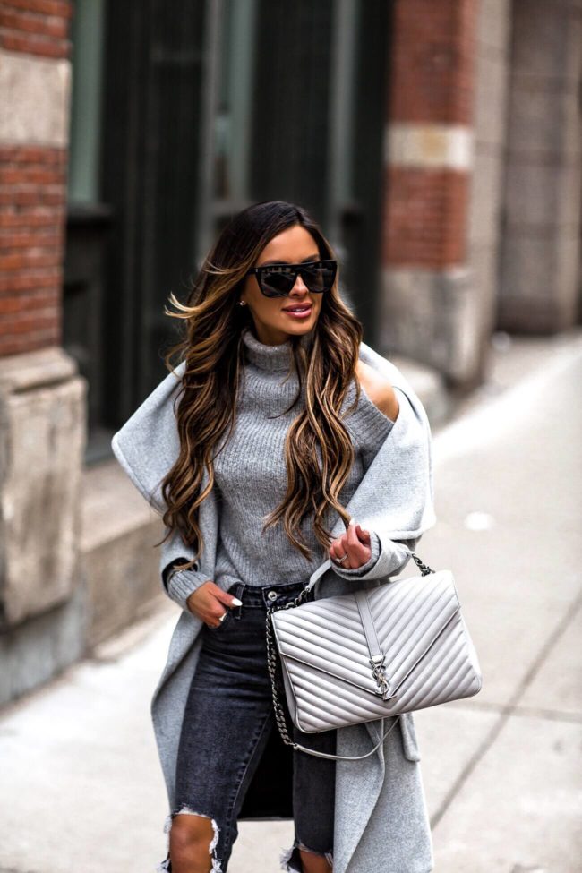 mia mia mine wearing a gray cold-shoulder top and ysl college bag
