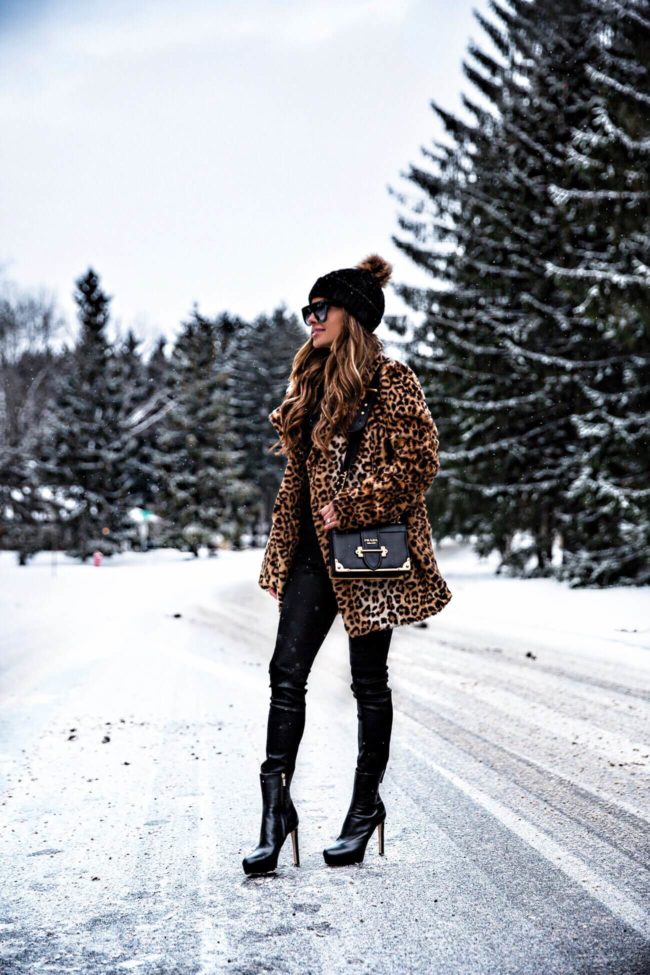fashion blogger mia mia mine wearing a leopard coat by joa and a pom pom beanie hat from asos
