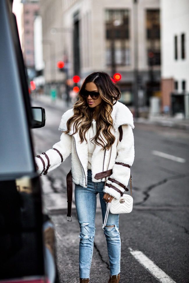 mia mia mine wearing an eaves bailey moto jacket from revolve and a gucci marmont bag