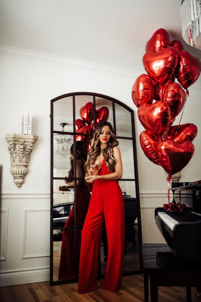 fashion blogger mia mia mine wearing a red romper from nordstrom with chanel perfume