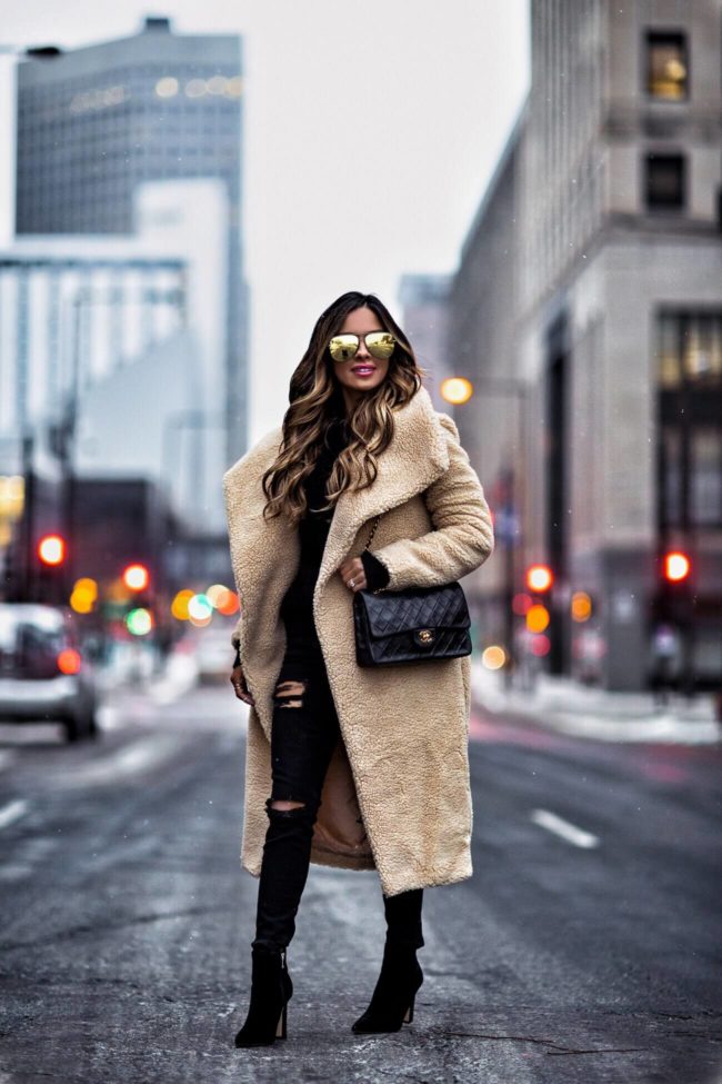 fashion blogger mia mia mine wearing a teddy bear coat and gold aviator sunglasses