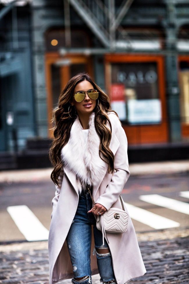 fashion blogger mia mia mine wearing a faux fur coat and gucci bag