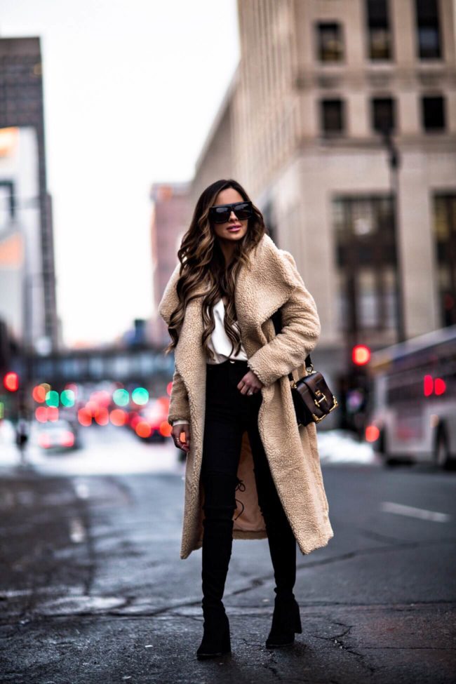 fashion blogger mia mia mine wearing a teddy bear coat and black denim from asos