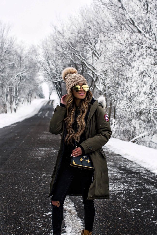 fashion blogger mia mia mine wearing a canada goose parka and prada cahier bag