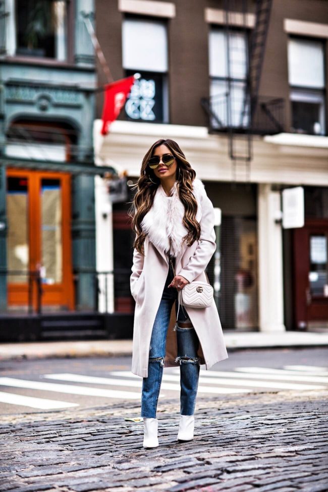 fashion blogger mia mia mine wearing a faux fur coat and gucci marmont bag