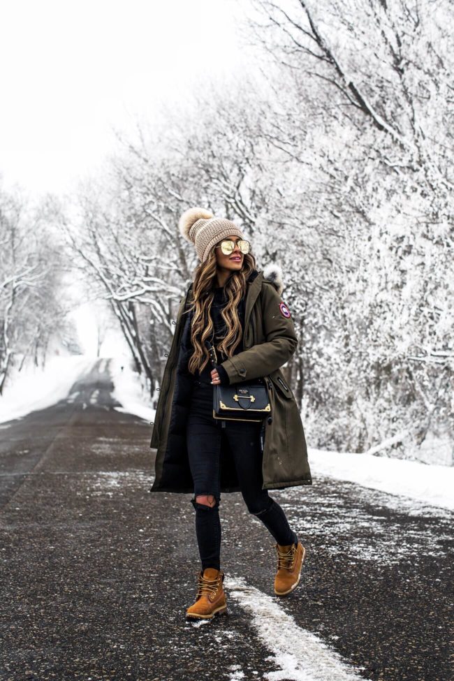 fashion blogger mia mia mine wearing timberland boots and a canada goose parka