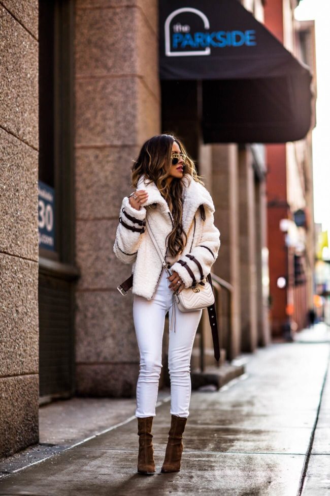 fashion blogger mia mia mine wearing a white eaves sherpa jacket from revolve and white denim