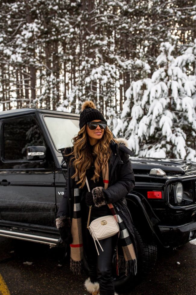 fashion blogger mia mia mine wearing a gucci marmont bag and pom pom beanie