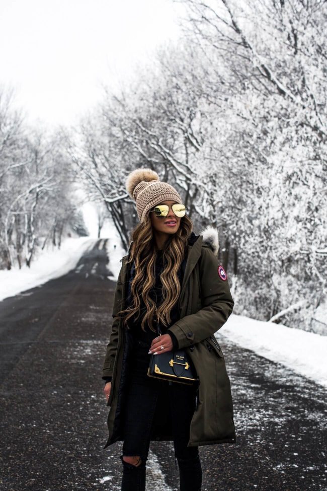 fashion blogger mia mia mine wearing a pom pom beanie and prada cahier bag