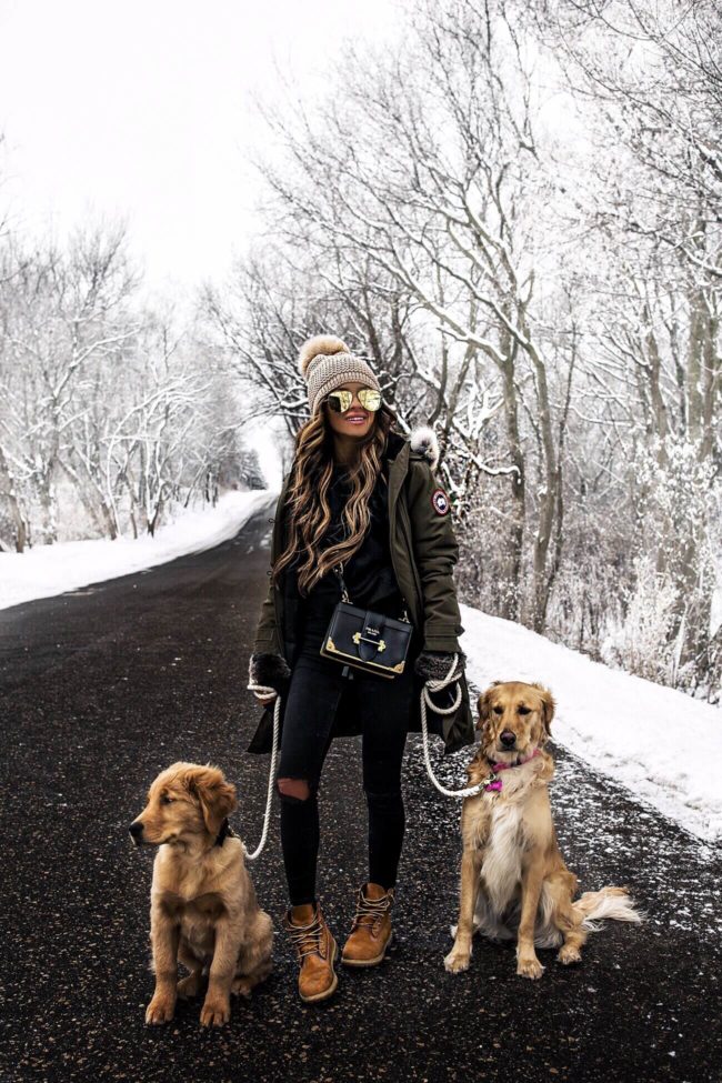 fashion blogger mia mia mine wearing a prada cahier bag and a canada goose parka